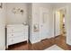 Charming Bedroom features a white dresser, decorative shelf, and hardwood floors at 2665 S Pennsylvania St, Denver, CO 80210