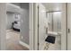 Hallway view of a modern bathroom featuring a glass-enclosed shower and updated vanity at 2665 S Pennsylvania St, Denver, CO 80210