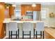 Open kitchen featuring stainless steel appliances, white countertops, sleek cabinetry, and bar stool seating at the island at 2665 S Pennsylvania St, Denver, CO 80210