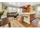 Inviting living room and kitchen area featuring hardwood floors, a kitchen island, and a comfortable seating area at 2665 S Pennsylvania St, Denver, CO 80210