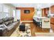 Welcoming living room and kitchen with hardwood floors, a kitchen island, and a leather couch at 2665 S Pennsylvania St, Denver, CO 80210