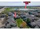 Aerial view of townhomes, green space, and Carpenter Park with a lake in the background under a partly cloudy sky at 3000 E 112 Ave # 102, Northglenn, CO 80233