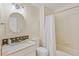 Bathroom features a granite countertop, patterned tile backsplash, and shower with tub at 3000 E 112 Ave # 102, Northglenn, CO 80233