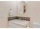 Bathroom featuring an granite countertop vanity and decorative backsplash at 3000 E 112 Ave # 102, Northglenn, CO 80233