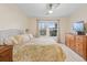 Primary bedroom with two windows, ceiling fan, and carpet at 3000 E 112 Ave # 102, Northglenn, CO 80233
