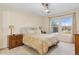Primary bedroom with two windows, and ceiling fan at 3000 E 112 Ave # 102, Northglenn, CO 80233