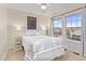 Bedroom featuring soft natural light with a ceiling fan and two large windows at 3000 E 112 Ave # 102, Northglenn, CO 80233