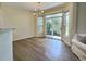 Dining room with modern chandelier, hardwood floors, and sliding door to backyard at 3000 E 112 Ave # 102, Northglenn, CO 80233