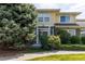 Charming two-story townhouse with mature trees and shrubs in the front yard at 3000 E 112 Ave # 102, Northglenn, CO 80233