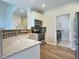 Open kitchen featuring white cabinets, stainless steel appliances, and mosaic tile backsplash with laundry room access at 3000 E 112 Ave # 102, Northglenn, CO 80233