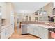 Bright kitchen with white cabinets, a farmhouse sink, stainless steel appliances, and natural light at 3000 E 112 Ave # 102, Northglenn, CO 80233