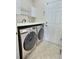 Laundry room featuring modern washer and dryer and storage shelving at 3000 E 112 Ave # 102, Northglenn, CO 80233