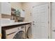 Laundry room with washer, dryer, cabinets, and countertop at 3000 E 112 Ave # 102, Northglenn, CO 80233