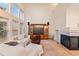 Spacious living room with a fireplace, large windows, entertainment center, and hardwood floors at 3000 E 112 Ave # 102, Northglenn, CO 80233