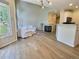 Sunlit living room with hardwood floors, fireplace, and white slipcovered seating at 3000 E 112 Ave # 102, Northglenn, CO 80233