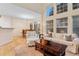 Cozy living room and dining area with natural light, hardwood floors, and comfortable furniture at 3000 E 112 Ave # 102, Northglenn, CO 80233