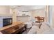 Open-concept living room flows into the kitchen and dining area, offering a cozy fireplace and hardwood flooring at 3000 E 112 Ave # 102, Northglenn, CO 80233