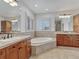 Large bathroom with double vanity, soaking tub, and separate shower at 9562 Silent Hills Ln, Lone Tree, CO 80124