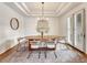 Modern dining room with an oval table and neutral decor at 9562 Silent Hills Ln, Lone Tree, CO 80124