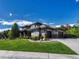 Two-story house with a large driveway and landscaped yard at 9562 Silent Hills Ln, Lone Tree, CO 80124