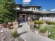 Welcoming front entrance with stone pillars and landscaping at 9562 Silent Hills Ln, Lone Tree, CO 80124