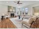 Living room with fireplace, hardwood floors, and large windows at 9562 Silent Hills Ln, Lone Tree, CO 80124