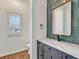 Powder room with green tile and modern vanity at 9562 Silent Hills Ln, Lone Tree, CO 80124