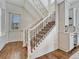 Elegant staircase with iron balusters and hardwood floors at 9562 Silent Hills Ln, Lone Tree, CO 80124