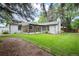 Charming backyard with lush green lawn and mature trees offering ample space for outdoor living at 2998 S Adams St, Denver, CO 80210