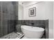 Luxurious bathroom featuring a freestanding tub and a separate glass-enclosed shower with gray tiling at 2998 S Adams St, Denver, CO 80210