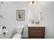 Modern bathroom features a wood vanity, brushed gold faucet, and light fixture at 2998 S Adams St, Denver, CO 80210