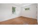 Minimalist bedroom with hardwood floors, two windows, and fresh, modern finishes at 2998 S Adams St, Denver, CO 80210