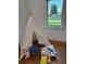 Bright bedroom showcasing play tent, natural light, and hardwood floors, ideal for  at 2998 S Adams St, Denver, CO 80210