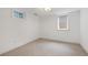 Neutral bedroom bathed in natural light showcases two windows and neutral carpet at 2998 S Adams St, Denver, CO 80210
