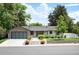 Charming single-story home with well-maintained landscaping, modern garage door, and inviting curb appeal at 2998 S Adams St, Denver, CO 80210