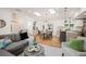 Open living room showcasing hardwood floors, multiple skylights, and seamless transition to kitchen and dining at 2998 S Adams St, Denver, CO 80210