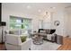 Cozy living room featuring hardwood floors, large windows, and comfortable seating at 2998 S Adams St, Denver, CO 80210