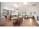 Bright, open-concept living space with hardwood floors, skylights, kitchen, and living areas at 2998 S Adams St, Denver, CO 80210