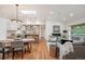 Bright, open-concept living space with hardwood floors, skylights, and kitchen at 2998 S Adams St, Denver, CO 80210