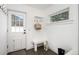 Bright mudroom features white bench seating with coat hooks and a window view at 2998 S Adams St, Denver, CO 80210