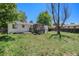 Home's backyard with lawn and shed, framed by trees at 16215 E Brunswick Dr, Aurora, CO 80013