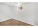 Cozy basement space with carpet flooring and a small window for natural light at 16215 E Brunswick Dr, Aurora, CO 80013