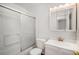 Clean white bathroom with a shower-tub combo and a vanity with a mirrored medicine cabinet at 16215 E Brunswick Dr, Aurora, CO 80013