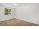Bedroom with neutral walls, carpet flooring, and a bright window at 16215 E Brunswick Dr, Aurora, CO 80013