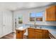 Galley kitchen featuring wood cabinets, laminate counters, and stainless steel appliances at 16215 E Brunswick Dr, Aurora, CO 80013