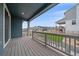 Back porch with wood floors and gray railings offer a scenic view of the backyard and neighborhood at 8268 Mt Harvard Rd, Littleton, CO 80125