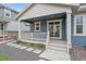 Back porch with sliding glass door and white railing provides easy access to the backyard at 8268 Mt Harvard Rd, Littleton, CO 80125