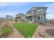 Backyard featuring a well-manicured lawn and rock landscaping, enclosed by a wooden fence at 8268 Mt Harvard Rd, Littleton, CO 80125