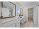 Bright bathroom featuring double vanity, framed mirrors, white cabinetry, and stylish tile flooring at 8268 Mt Harvard Rd, Littleton, CO 80125