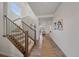 Inviting entryway featuring wood floors, staircase with iron spindles, and an open view of the living area at 8268 Mt Harvard Rd, Littleton, CO 80125